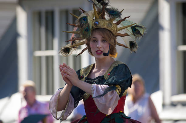A woman dressed in Biblical clothing raising her hand as if in prayer or to beg. Could be the Virgin Mary.