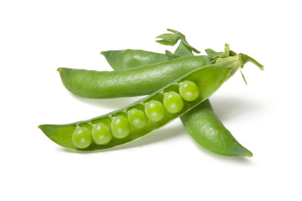 istock Green fresh peas isolated on white background 1015406092