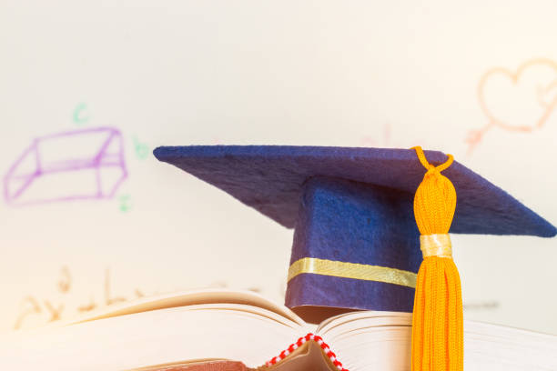 istock Education Graduate mortarboard blue hat on textbook with formula equation graph or Mathematics on screen, Ideas for knowledge learning success in study abroad international university, Back to School 1015408802