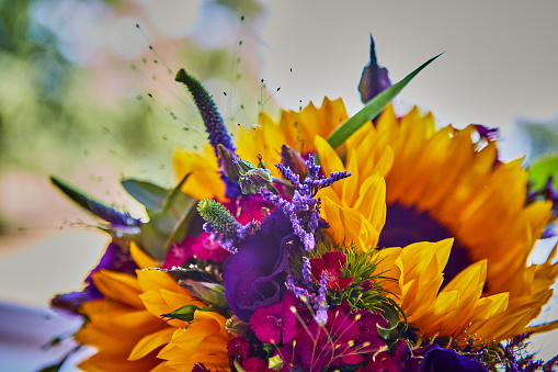 British Wedding venue showing bright floral contemporary flower arrangements, rustic table settings with place cards and meadow flowers alongside traditional and contemporary wedding favours