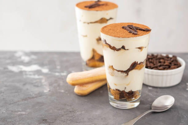 istock Tiramisu in a glass with coffee beans on grey background. Copy space. Selective focus. 1015410260