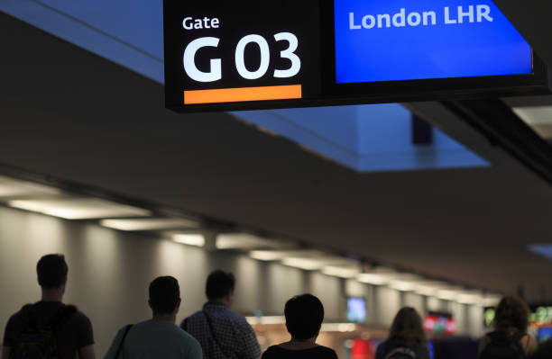 airport interior with passenger silhouettes, gate number three board and destination 'london heathrow airport' (lhr) - heathrow airport imagens e fotografias de stock