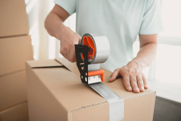 istock Close up. Packing Cartboard Boxes with Tape . 1015413278