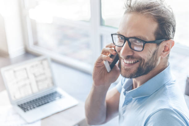 istock Handsome Young Businessman Talking on Mobile Phone 1015413624