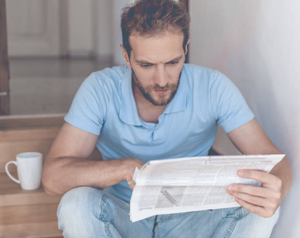 istock White Businessman Rest on Stairs Reading Newspaper 1015413634