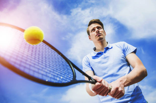 istock Happy Tennis Player Ready to Hit Ball with Racket 1015414002
