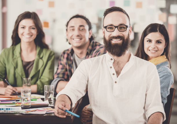 istock Group of Young Designers Discuss New Project. 1015414412
