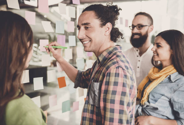 istock Group of Young Designers Discuss New Project. 1015414430