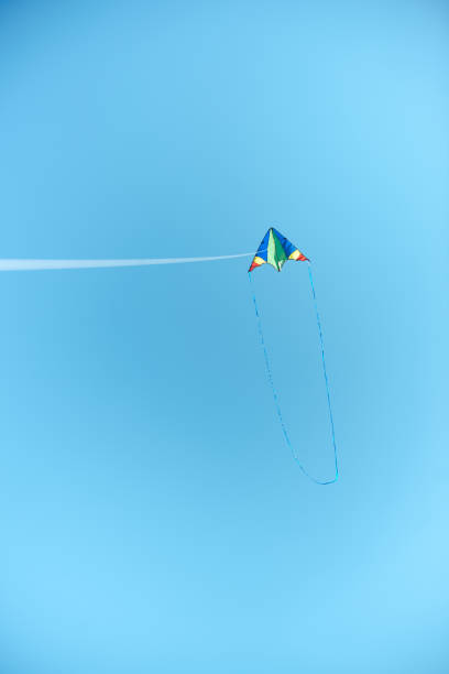 istock colorful kite flying high in blue clear sky 1015430174
