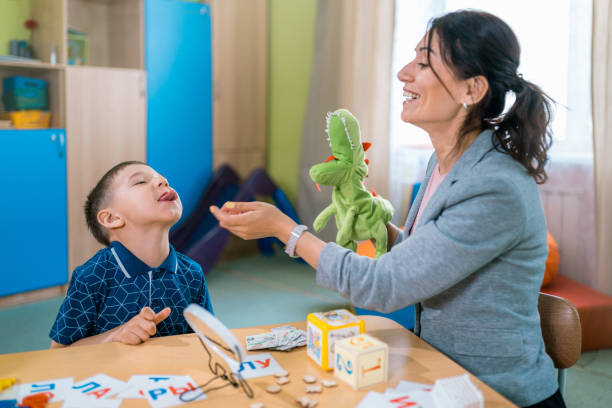 istock Woman Speech Therapist Teaches Boy To Correct His Pronunciation 1015434058
