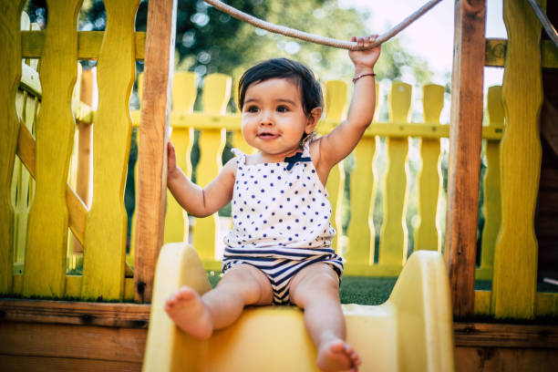 The baby is playing outside The baby is playing outside swing play equipment photos stock pictures, royalty-free photos & images