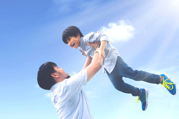 istock Father lifts his son with happy expression 1015437306
