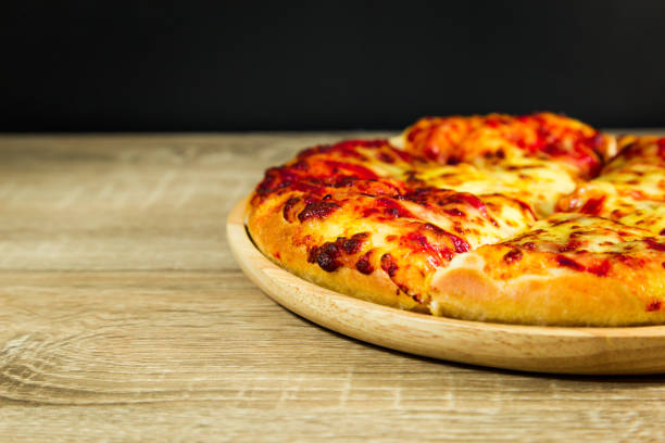 istock Pizza Margarita with mozzarella cheese on a wooden table. 1015437736