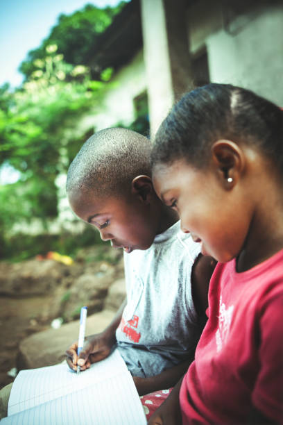 istock African child  reading a book outdoors 1015438240
