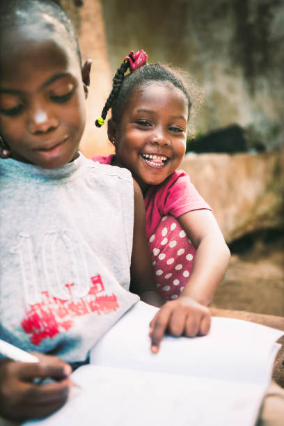istock African child  reading a book outdoors 1015438332