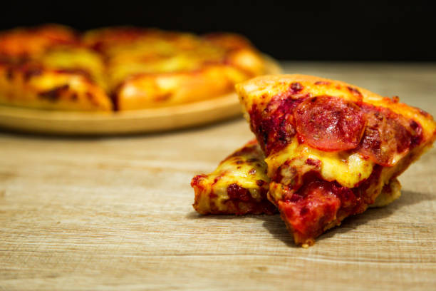istock American pizza with pepperoni on a wooden table. 1015439448