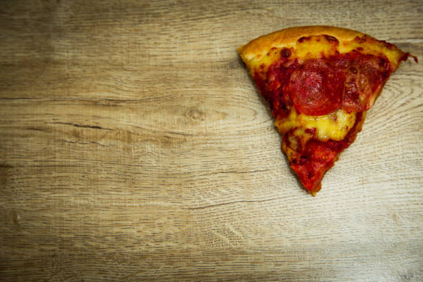 istock American pizza with pepperoni on a wooden table. 1015441820