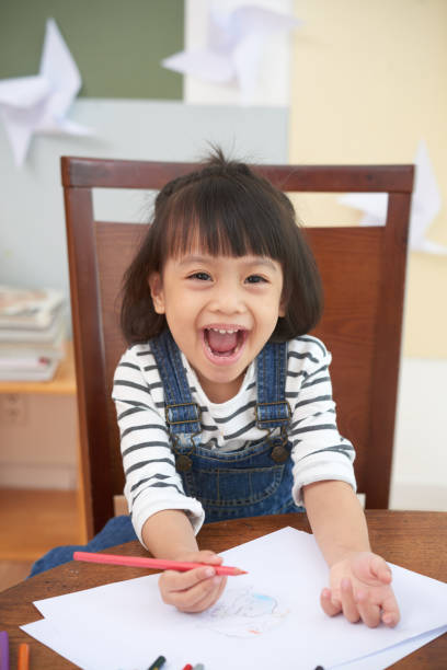 istock Smiling happy girl with pencils 1015443674