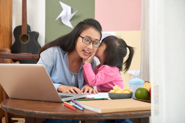 istock Charming girl telling secrets to mother 1015443726