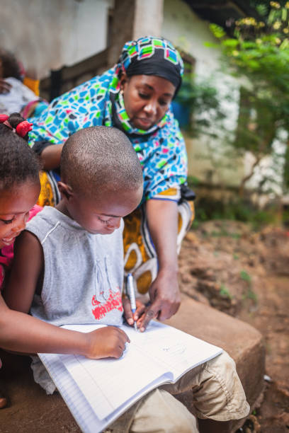 istock african Child doing her homework with her mother 1015443906