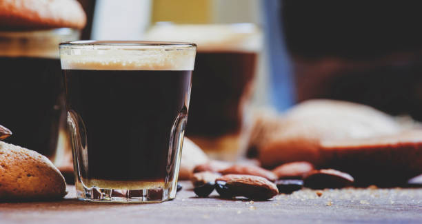 istock Black coffee and almond biscuits, vintage wooden background, selective focus and toned image 1015446488