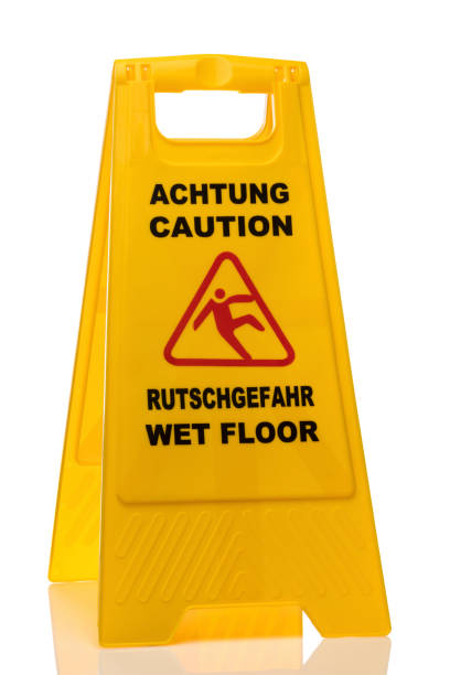 istock Bilingual slippery floor warning sign isolated 1015447976