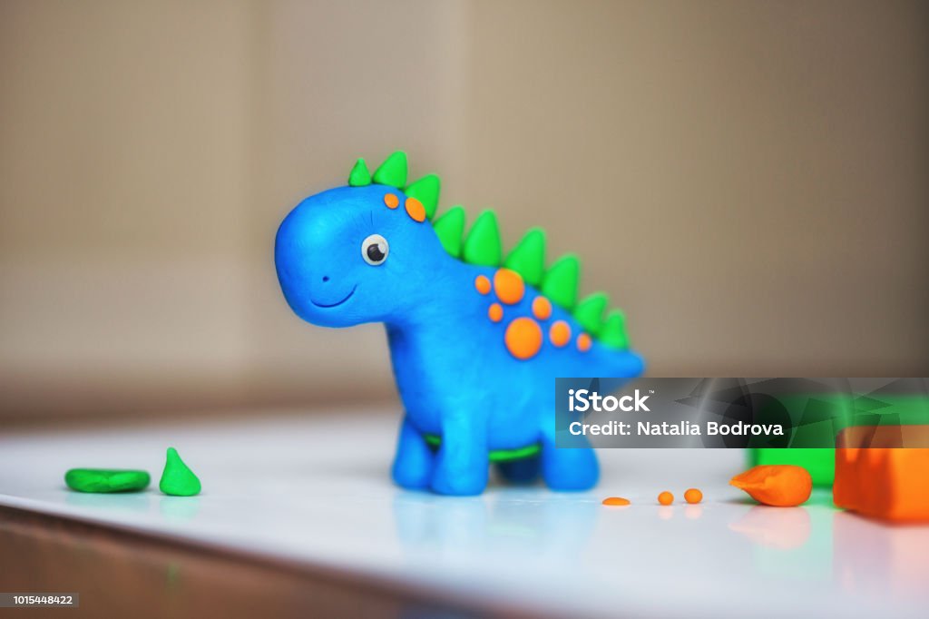 children's creativity. figurine of plasticine. toy animal dinosaur children's creativity. figurine of plasticine Child's Play Clay Stock Photo