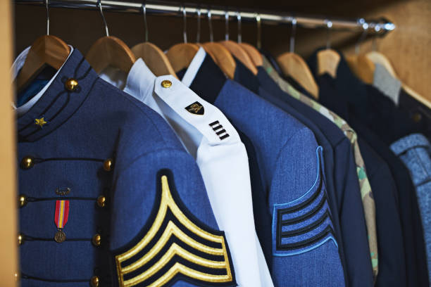 The closet of heroes Shot of various military jackets hanging in a closet officer military rank stock pictures, royalty-free photos & images