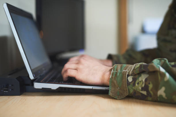 Keeping his loved ones close to him Cropped shot of a soldier using a laptop in the dorms of a military academy barracks photos stock pictures, royalty-free photos & images