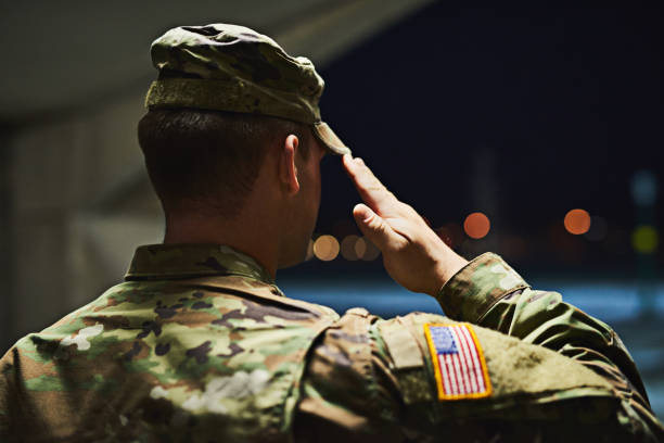 Loyal is the soldier who loves his country Rearview shot of a young soldier standing at a military academy and saluting us military stock pictures, royalty-free photos & images