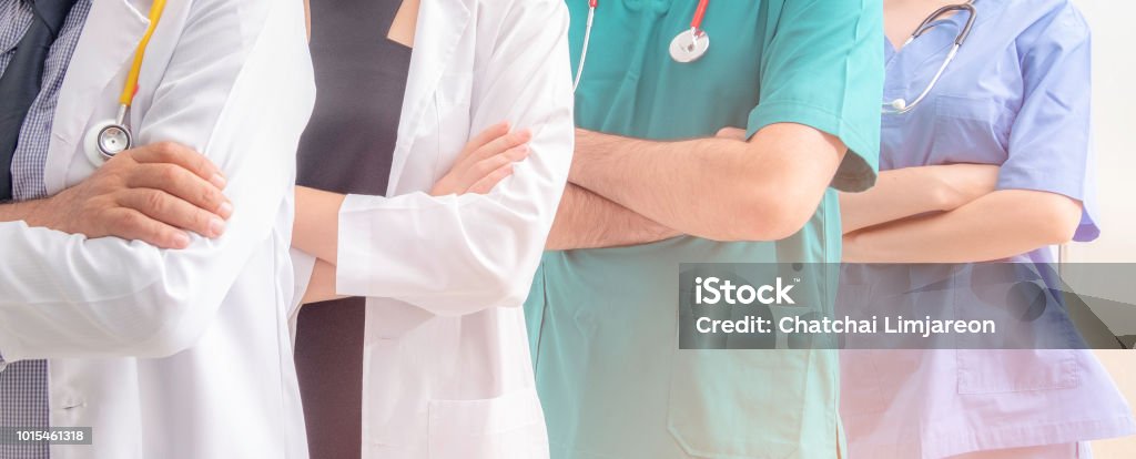 Doctors and nurses with uniform and stethoscope coordinate hands. Concept Teamwork in hospital for success work and trust in team Doctor Stock Photo