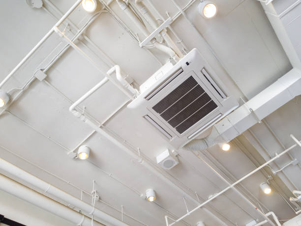 istock White Industrial air conditioner cooling pipe with plumbing at ceiling. Ventilation system ceiling air duct. 1015461342