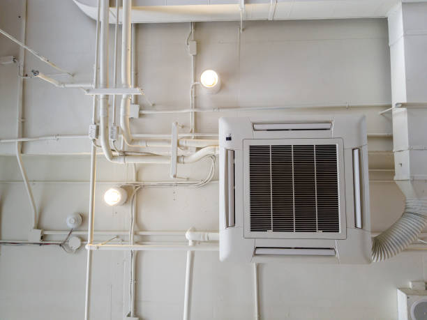 istock White Industrial air conditioner cooling pipe with plumbing at ceiling. Ventilation system ceiling air duct. 1015461350