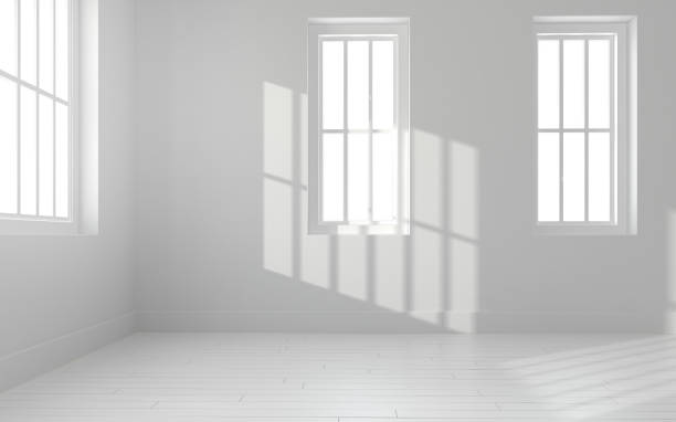 istock 3D rendering of white room space with interior lighting and sun light cast the window shadow on the wall and floor,Perspective of minimal design architecture. 3d rendering 1015464610