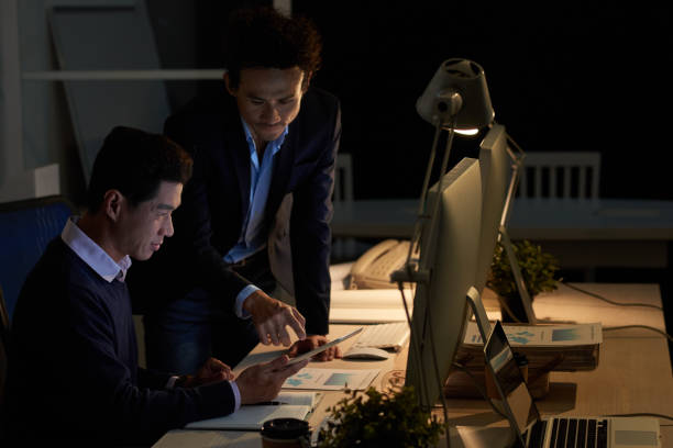 istock Asian businessmen working late in office 1015471772