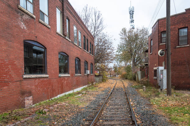 istock Empty Railroad Track between Buildings on an Overcast Fall Day 1015475164