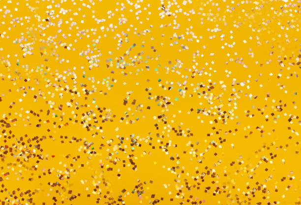 istock Seamless gold glitter texture isolated on yellow background. 1015476064