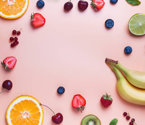 istock Different fruits and berries on the pastel color background. 1015481892