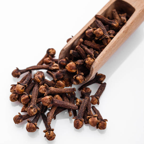 istock fragrant cloves on a white acrylic background 1015494938