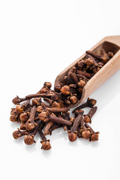 istock fragrant cloves on a white acrylic background 1015494940