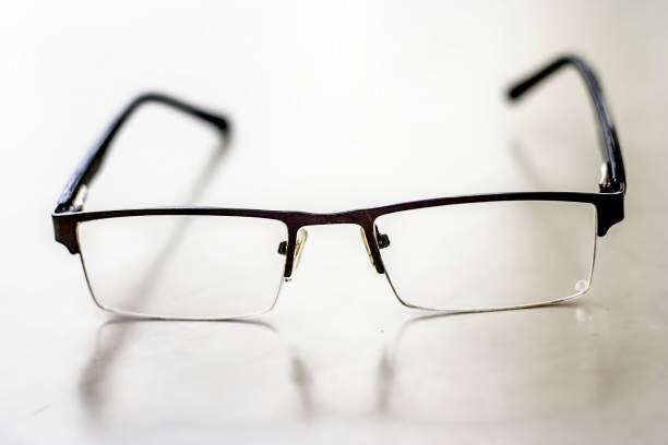 istock Black colored half frame rim reading glasses or spectacles to cure eye disease myopia. 1015495130