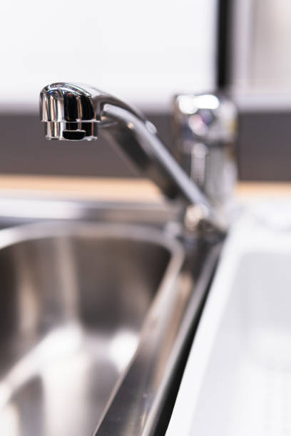 istock A stainess steel tap on blurred background. 1015495380