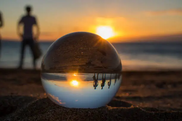 Sunset on Hawaii beach shot through glass ball