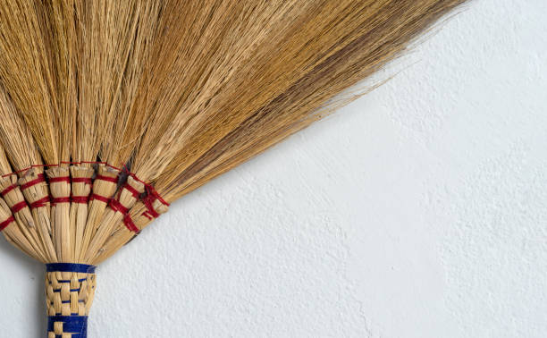 istock closeup broom on white brick wall background 1015499668