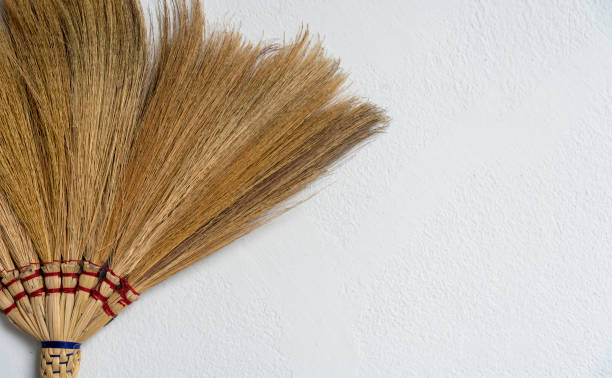 istock closeup broom on white brick wall background 1015499672