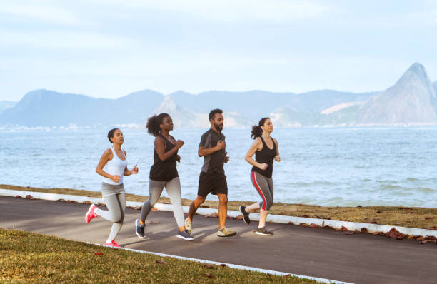 istock brazilian friends jogging at beach against sky 1015500836