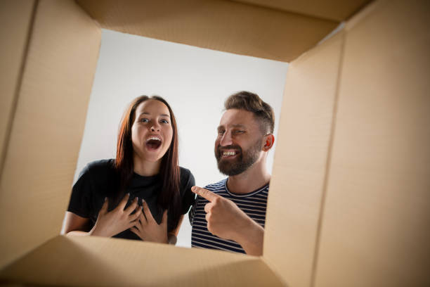istock The couple unpacking and opening carton box and looking inside 1015500918