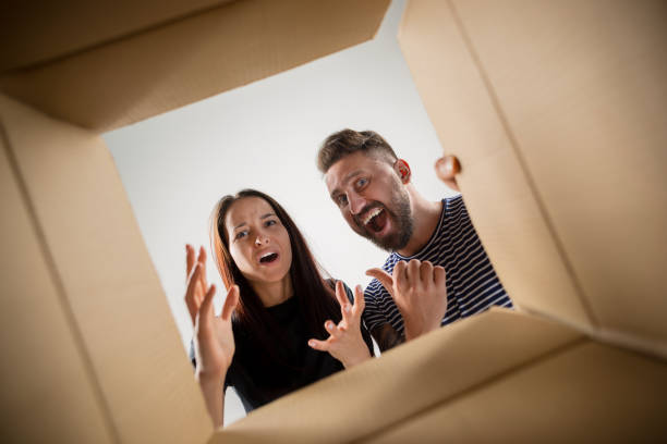 istock The couple unpacking and opening carton box and looking inside 1015505476