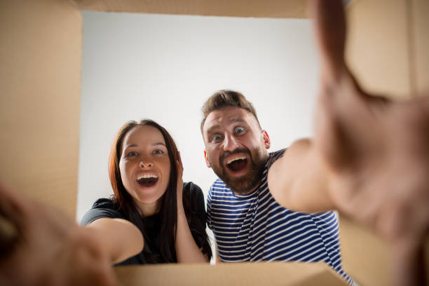 istock The couple unpacking and opening carton box and looking inside 1015512356