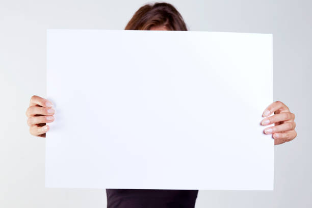 istock Business woman keeps a blank placard 1015512432